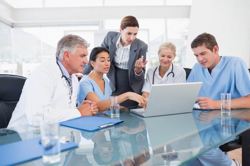 Team of doctors and businesswoman having a meeting in medical of